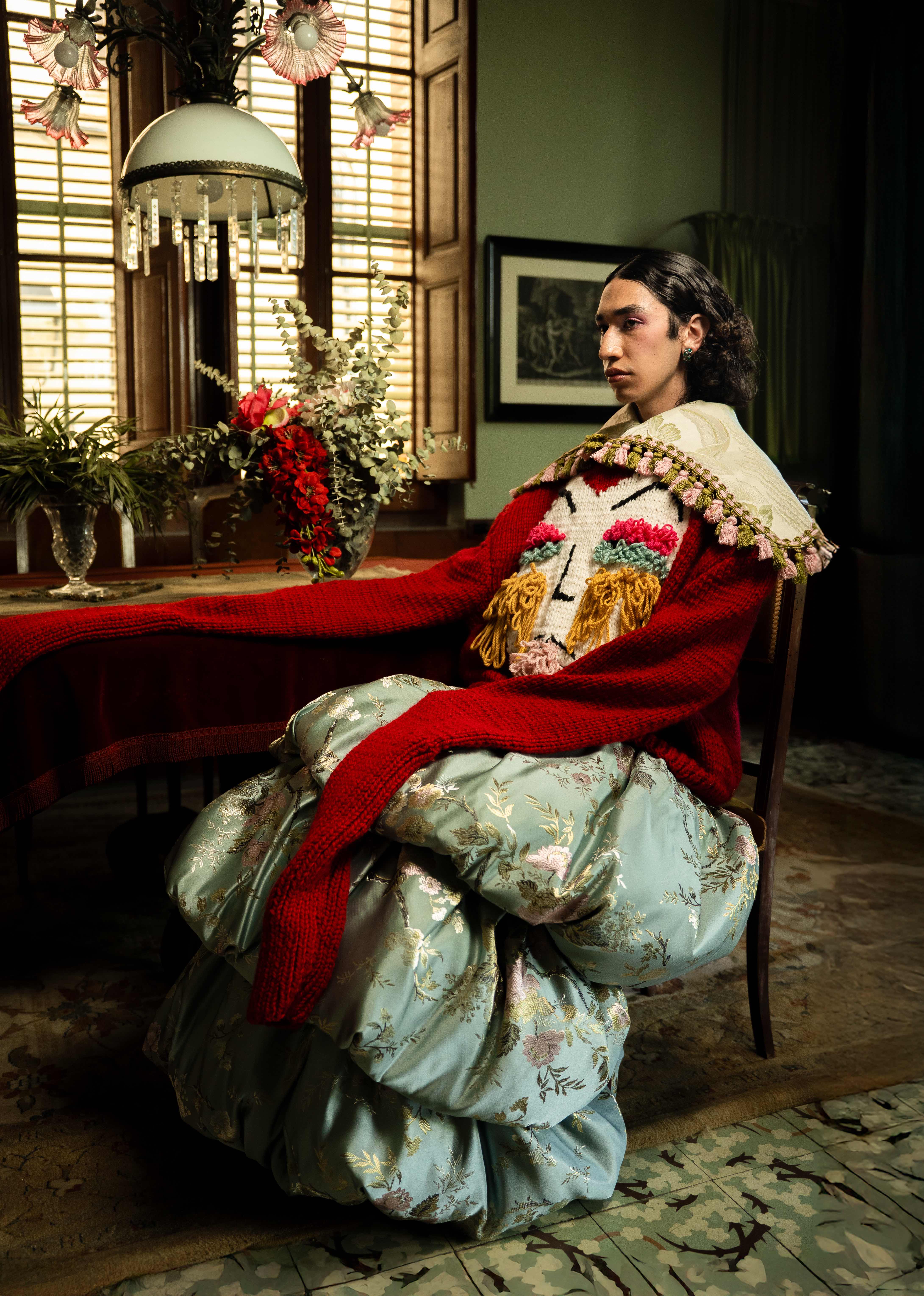 Mona Puppet Riot FW25 — model in hand-knit red sweater, custom knitwear design Mariona Ramos