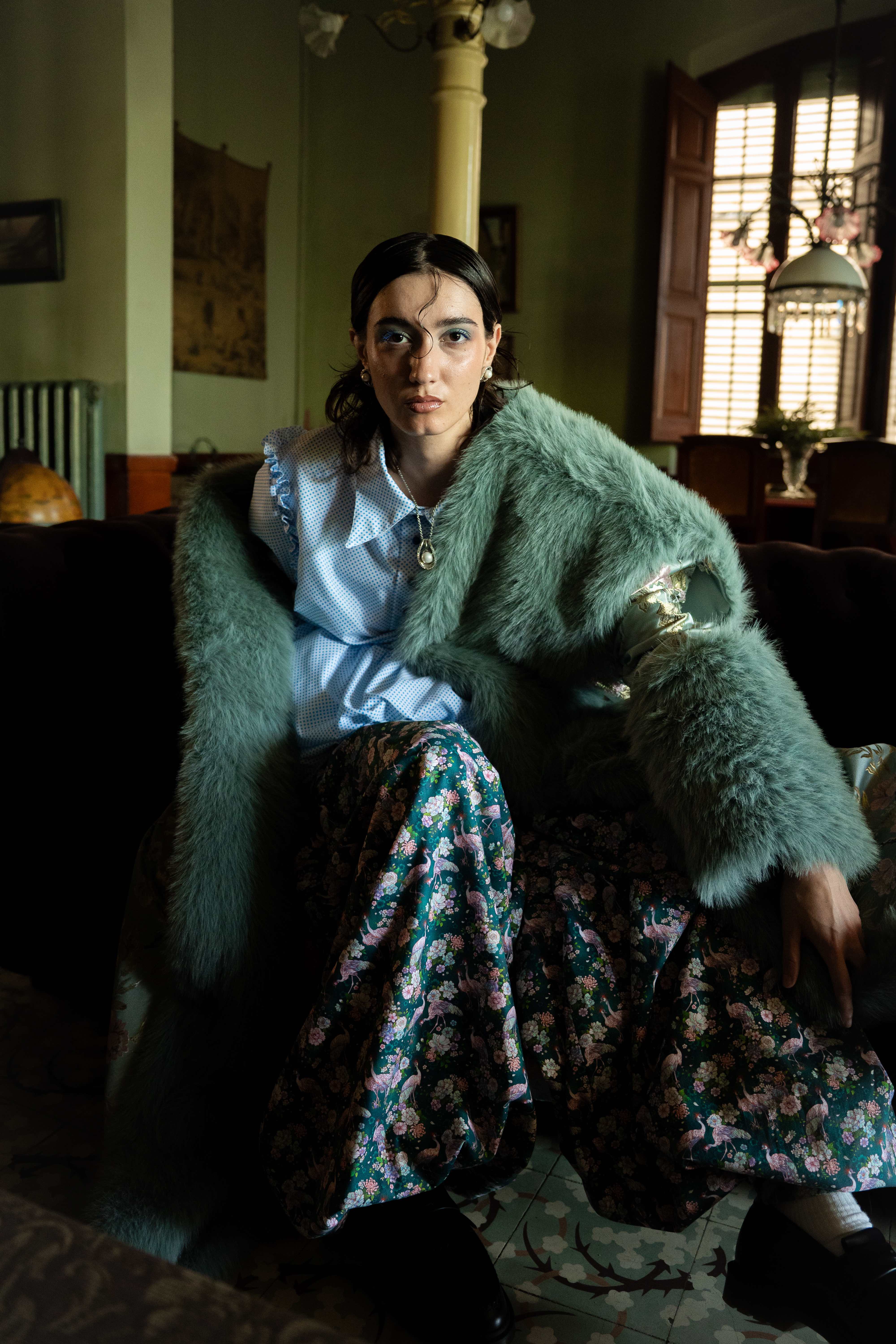 Mona Puppet Riot FW25 — model in teal vintage fur coat, theatrical fashion Barcelona