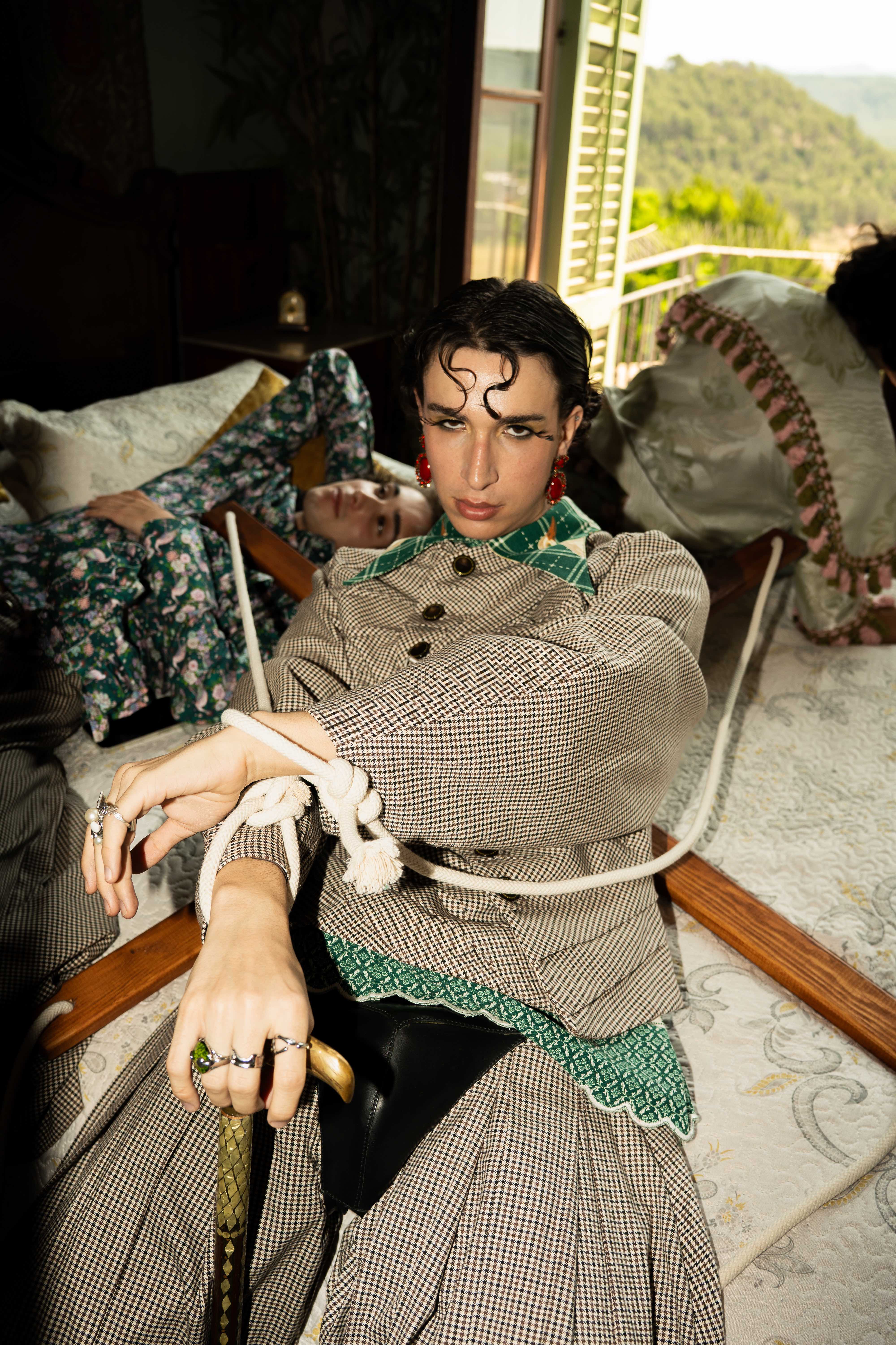 Mona Puppet Riot FW25 — two models in checkered repurposed fabric outfits, bespoke fashion Barcelona